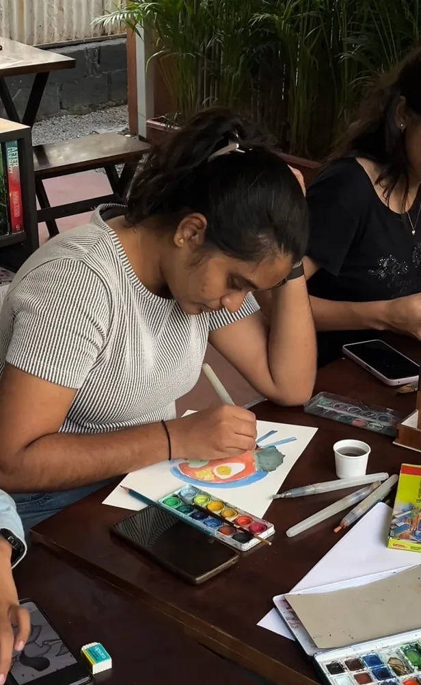 An artist painting with watercolours at a Communitie workshop