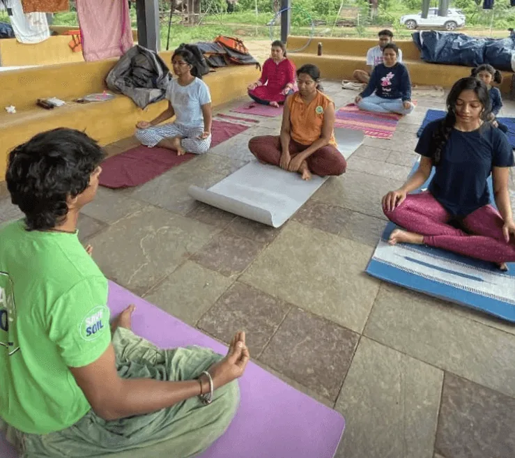 People sitting together on yoga mats