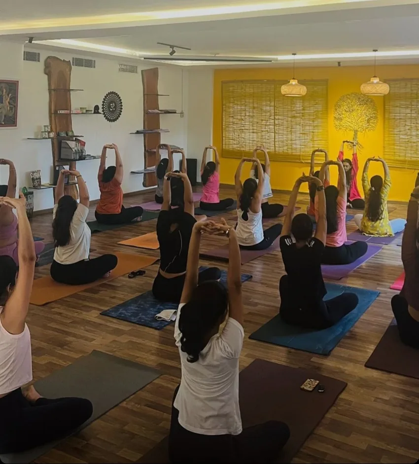 A yoga class stretching together